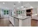 Open-concept kitchen with a large island, stainless steel appliances, and a view of the living room with fireplace at 2980 Prestwood Dr, Cumming, GA 30040