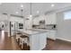 Bright kitchen featuring white cabinets, a granite island with seating, and stainless steel appliances at 2980 Prestwood Dr, Cumming, GA 30040