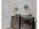 Convenient laundry area with modern washer and dryer units and shelving for storage at 2980 Prestwood Dr, Cumming, GA 30040