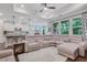 Bright and open living room features a large sectional sofa and seamlessly connects to the kitchen area at 2980 Prestwood Dr, Cumming, GA 30040