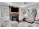 Gathering room featuring a fireplace, built-in shelving, and staircase access at 2980 Prestwood Dr, Cumming, GA 30040