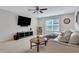 Spacious living room featuring a large sectional sofa, TV and ample natural light at 2980 Prestwood Dr, Cumming, GA 30040