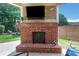 Cozy outdoor fireplace perfect for cool evenings and entertaining guests at 2980 Prestwood Dr, Cumming, GA 30040