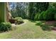 Well-maintained lawn with garden landscaping and curved concrete path, backing to mature trees at 3359 Villa Ln, Douglasville, GA 30135