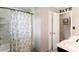 Neutral bathroom featuring tub and shower with decorative starfish curtain and modern neutral tile at 3359 Villa Ln, Douglasville, GA 30135