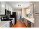 Well-lit kitchen featuring sleek countertops, stainless steel appliances, and ample cabinet space at 3359 Villa Ln, Douglasville, GA 30135