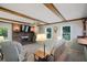 Cozy living room features beamed ceiling and brick fireplace at 3359 Villa Ln, Douglasville, GA 30135