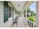 Cozy covered porch with outdoor seating and a view of the neighborhood and surrounding landscaping at 3359 Villa Ln, Douglasville, GA 30135