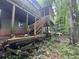 Backyard area and stairs with covered porch on a home in a forest like setting at 372 Nalley Dr, Stone Mountain, GA 30087