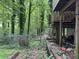 Backyard showing fencing and stairs leading to a deck on a heavily wooded lot at 372 Nalley Dr, Stone Mountain, GA 30087