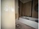 Bathroom with a bathtub, partially removed drywall, and plumbing in need of renovation at 372 Nalley Dr, Stone Mountain, GA 30087