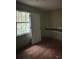 Bedroom featuring hardwood floors, a window view, and closet at 372 Nalley Dr, Stone Mountain, GA 30087