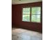 Bedroom with freshly painted walls, hardwood floors, and view to greenery outside the window at 372 Nalley Dr, Stone Mountain, GA 30087