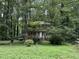 Front exterior of a two-story home surrounded by mature trees at 372 Nalley Dr, Stone Mountain, GA 30087