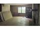 Spacious living room featuring hardwood floors, a stone fireplace, and natural light from a large window at 372 Nalley Dr, Stone Mountain, GA 30087