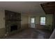 Cozy living room showcasing a stone fireplace and an exit door to the back yard at 372 Nalley Dr, Stone Mountain, GA 30087