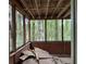 Enclosed porch featuring wood-trimmed screens and a view of the surrounding woodland at 372 Nalley Dr, Stone Mountain, GA 30087