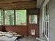 Enclosed porch showcasing wood trim and natural lighting, adjacent to door and green backyard at 372 Nalley Dr, Stone Mountain, GA 30087