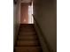 View of wooden stairs with a handrail, illuminated by natural light at 372 Nalley Dr, Stone Mountain, GA 30087