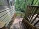 Wooden stairway leading down from weathered siding at 372 Nalley Dr, Stone Mountain, GA 30087