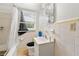 Compact bathroom features a shower-tub combo, white fixtures, and tiled walls with natural light at 6250 Graceland Cir, Morrow, GA 30260