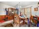 Dining room with a wooden table, floral curtains, and a vintage china cabinet at 6250 Graceland Cir, Morrow, GA 30260