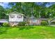Charming home featuring a brick facade, white siding, and a lush green lawn at 6250 Graceland Cir, Morrow, GA 30260