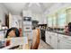 Compact kitchen features white cabinets, essential appliances, and a dining area at 6250 Graceland Cir, Morrow, GA 30260