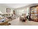 Cozy living room featuring two sofas, a patterned chair, and a display case at 6250 Graceland Cir, Morrow, GA 30260