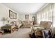 Cozy living room with patterned sofas, a large window, and neutral carpeting at 6250 Graceland Cir, Morrow, GA 30260