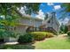 Spacious two-story home featuring a wooden deck, well manicured lawn, and mature trees at 1464 Chatsworth Trace, Lawrenceville, GA 30044