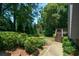 Well-manicured backyard with mature trees and lush landscaping at 1464 Chatsworth Trace, Lawrenceville, GA 30044