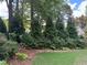 Landscaped backyard with lush greenery and mature trees offering privacy at 1464 Chatsworth Trace, Lawrenceville, GA 30044