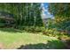 A lush green backyard with mature trees and landscaping at 1464 Chatsworth Trace, Lawrenceville, GA 30044
