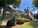View of the back of the house from the backyard, featuring a deck and lush landscaping at 1464 Chatsworth Trace, Lawrenceville, GA 30044