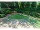 Well-manicured backyard featuring mature landscaping and lawn at 1464 Chatsworth Trace, Lawrenceville, GA 30044