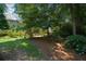 A well-maintained backyard with lush greenery, mature trees and landscaping at 1464 Chatsworth Trace, Lawrenceville, GA 30044