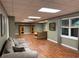 Spacious basement Gathering room with wood floors and large windows for natural light at 1464 Chatsworth Trace, Lawrenceville, GA 30044
