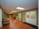 Finished basement area with laminate flooring, a large seating area, and a door to the backyard at 1464 Chatsworth Trace, Lawrenceville, GA 30044