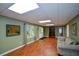 Cozy basement features laminate floors, soft green walls, and tasteful furnishings at 1464 Chatsworth Trace, Lawrenceville, GA 30044