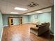 Spacious finished basement with wood-look flooring, built-in shelving, and comfortable seating areas at 1464 Chatsworth Trace, Lawrenceville, GA 30044