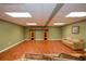 Inviting basement with laminate flooring, built-in shelving, and recessed lighting at 1464 Chatsworth Trace, Lawrenceville, GA 30044