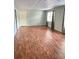Open basement area with wood floors, drop ceiling, and natural light at 1464 Chatsworth Trace, Lawrenceville, GA 30044