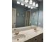 Bright bathroom features a double sink vanity with white countertops and updated lighting at 1464 Chatsworth Trace, Lawrenceville, GA 30044