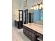 The primary bathroom offers dual vanities, a tile floor, and a large mirror, with a doorway leading to a bedroom at 1464 Chatsworth Trace, Lawrenceville, GA 30044