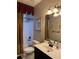 Bathroom featuring a shower/tub combination, toilet, vanity with sink, and decorative mirror and lighting at 1464 Chatsworth Trace, Lawrenceville, GA 30044