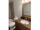 Well-lit bathroom showcases a granite-topped vanity and a shower with glass doors at 1464 Chatsworth Trace, Lawrenceville, GA 30044