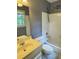 Bathroom featuring a vanity, toilet, tub/shower with tile surround, and a window for natural light at 1464 Chatsworth Trace, Lawrenceville, GA 30044