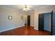 Comfortable bedroom with hardwood floors, an open closet, and neutral paint at 1464 Chatsworth Trace, Lawrenceville, GA 30044