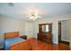 Bedroom featuring hardwood floors, dresser and a large window giving ample natural light at 1464 Chatsworth Trace, Lawrenceville, GA 30044